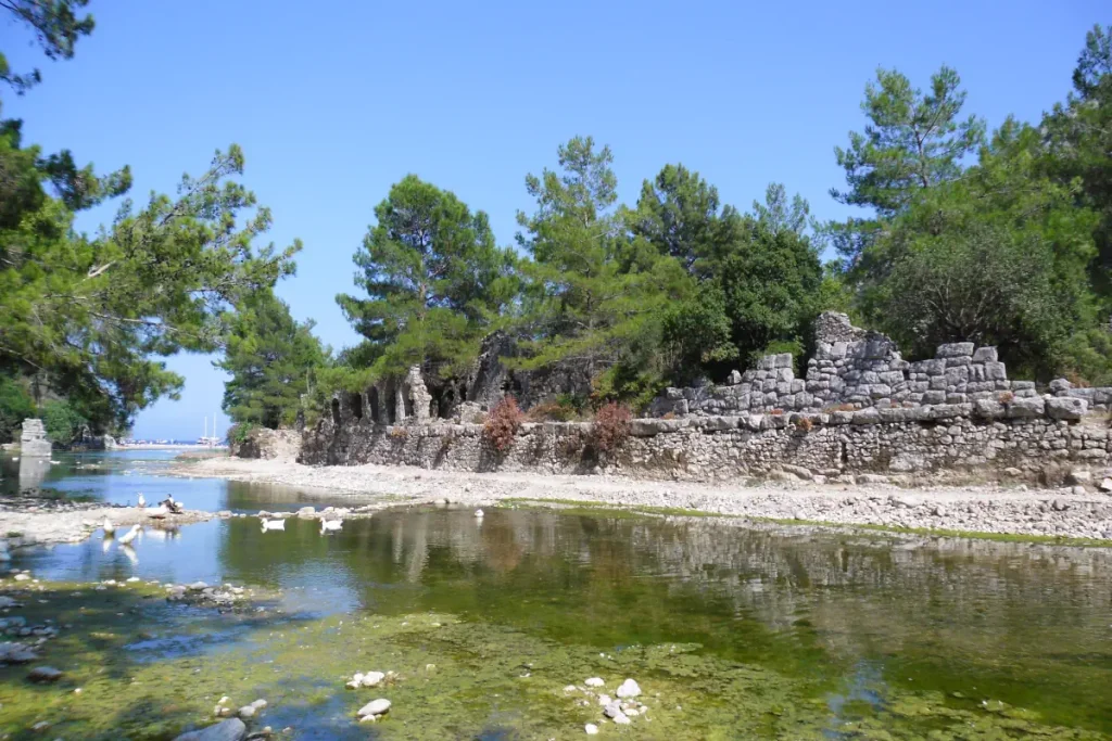 The river flowing through Olympos, with the Roman Bathhouse on the side, and the beach visible at the river's end.