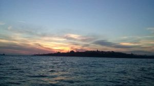 Sunset behind historic peninsula of Istanbul (Byzantium), a photo I took aboard a ferry in 2015. From left to right, the silhouettes of the Blue Mosque, Hagia Sophia, Beyazıt Tower, New Mosque, and Süleymaniye Mosque can be seen.