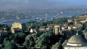 A 1956 photo of the Bosphorus. The photo was taken from the Anatolian side of Istanbul. The Bosphorus, boats, Dolmabahçe Palace, and Dolmabahçe Mosque can be seen in the photo.